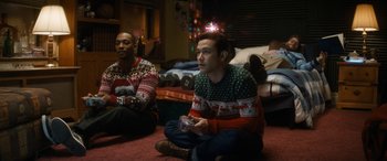 Movie still from “The Night Before” (2015), directed by Jonathan Levine – Two men sitting on the ground playing a video game; Medium shot, High angle