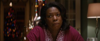 Movie still from “The Night Before” (2015), directed by Jonathan Levine – A woman in a pink shirt is looking at the camera; Close Up shot, Over the shoulder angle