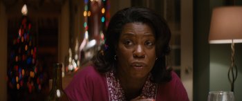 Movie still from “The Night Before” (2015), directed by Jonathan Levine – An older black woman looking at the camera; Close Up shot, Over the shoulder angle