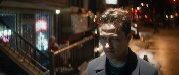 Movie still from “The Night Before” (2015), directed by Jonathan Levine – A man standing in the street at night with lights in the background; Close Up shot, Over the shoulder angle