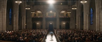 Movie still from “The Night Before” (2015), directed by Jonathan Levine – A man standing in front of an audience in front of an auditorium; Extreme Wide shot, High angle
