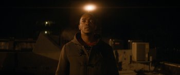 Movie still from “The Night Before” (2015), directed by Jonathan Levine – A man standing in the dark under a light; Close Up shot, Low angle