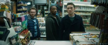 Movie still from “The Night Before” (2015), directed by Jonathan Levine – A group of men standing in a store; Medium shot, Over the shoulder angle