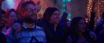 Movie still from “The Night Before” (2015), directed by Jonathan Levine – A group of people that are standing in a room; Close Up shot, Over the shoulder angle