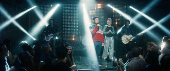 Movie still from “The Night Before” (2015), directed by Jonathan Levine – A man and a woman singing on a stage; Wide shot, Over the shoulder angle