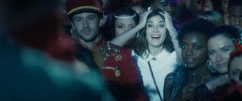 Movie still from “The Night Before” (2015), directed by Jonathan Levine – A man and a woman are smiling for the camera; Close Up shot, Over the shoulder angle