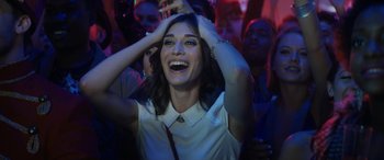 Movie still from “The Night Before” (2015), directed by Jonathan Levine – A woman in a white shirt is laughing; Close Up shot, High angle