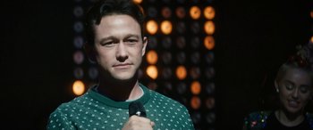 Movie still from “The Night Before” (2015), directed by Jonathan Levine – A person holding a microphone; Close Up shot, Over the shoulder angle