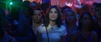 Movie still from “The Night Before” (2015), directed by Jonathan Levine – A group of people standing in a room with lights on; Close Up shot, Over the shoulder angle