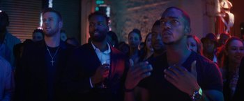 Movie still from “The Night Before” (2015), directed by Jonathan Levine – A group of people standing in a dark room; Close Up shot, Over the shoulder angle