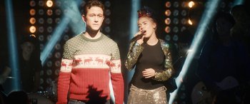 Movie still from “The Night Before” (2015), directed by Jonathan Levine – A man and a woman are singing on a stage; Medium shot, Over the shoulder angle