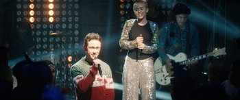 Movie still from “The Night Before” (2015), directed by Jonathan Levine – A man and a woman singing on stage; Medium shot, Over the shoulder angle