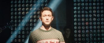 Movie still from “The Night Before” (2015), directed by Jonathan Levine – A man wearing a christmas sweater standing in front of a wall; Close Up shot, Over the shoulder angle