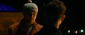 Movie still from “The Night Before” (2015), directed by Jonathan Levine – A man wearing a hat looking into a mirror; Close Up shot, Over the shoulder angle