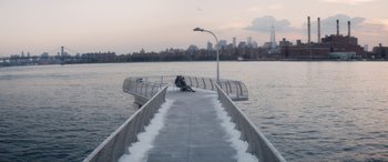 Movie still from “The Night Before” (2015), directed by Jonathan Levine – Two people sitting on a pier next to a body of water; Extreme Wide shot, High angle