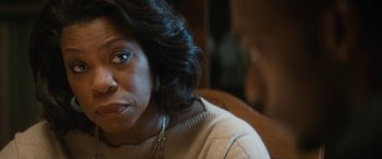 Movie still from “The Night Before” (2015), directed by Jonathan Levine – A person sitting on a couch; Close Up shot, Over the shoulder angle