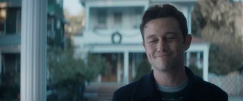 Movie still from “The Night Before” (2015), directed by Jonathan Levine – A person smiling with a house in the background; Close Up shot, Over the shoulder angle
