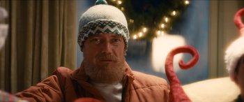 Movie still from “The Night Before” (2015), directed by Jonathan Levine – A man with a beard wearing a knitted hat; Close Up shot, Over the shoulder angle