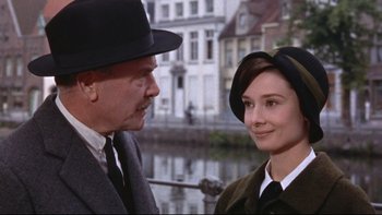 Movie still from “The Nun's Story” (1959), directed by Fred Zinnemann – An older man and a younger woman in a hat and tie; Close Up shot, Over the shoulder angle