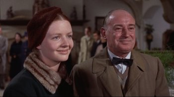Movie still from “The Nun's Story” (1959), directed by Fred Zinnemann – A man and a woman standing next to each other; Medium shot, Low angle