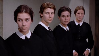 Movie still from “The Nun's Story” (1959), directed by Fred Zinnemann – A group of young people standing next to each other; Medium shot, Low angle