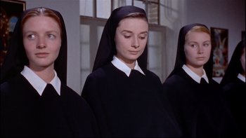 Movie still from “The Nun's Story” (1959), directed by Fred Zinnemann – Three women in black and white outfits standing next to each other in front of a window; Close Up shot, Low angle