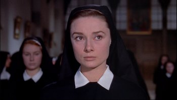 Movie still from “The Nun's Story” (1959), directed by Fred Zinnemann – A woman wearing a nun's habit in a movie scene; Close Up shot, Low angle
