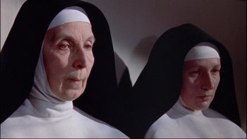 Movie still from “The Nun's Story” (1959), directed by Fred Zinnemann – A woman in a nun's outfit is reflected in a mirror; Close Up shot, High angle