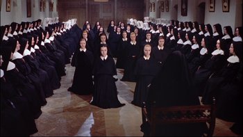 Movie still from “The Nun's Story” (1959), directed by Fred Zinnemann – A large group of people dressed as nuns; Extreme Wide shot, High angle