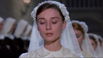 Movie still from “The Nun's Story” (1959), directed by Fred Zinnemann – A person wearing a wedding dress; Close Up shot, Over the shoulder angle