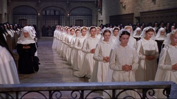 Movie still from “The Nun's Story” (1959), directed by Fred Zinnemann – A group of women in white dresses standing next to each other; Wide shot, High angle