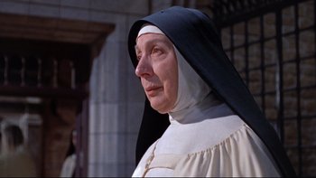 Movie still from “The Nun's Story” (1959), directed by Fred Zinnemann – An older woman wearing a nun's outfit; Close Up shot, Low angle