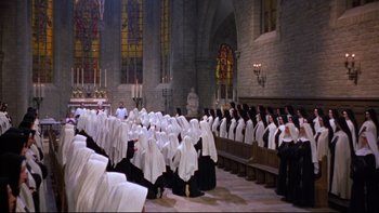 Movie still from “The Nun's Story” (1959), directed by Fred Zinnemann – A group of people in a church with white robes; Extreme Wide shot, High angle