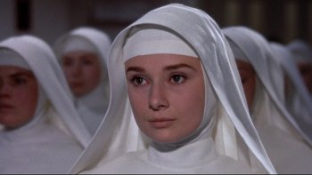 Movie still from “The Nun's Story” (1959), directed by Fred Zinnemann – A woman wearing a white veil and a white head covering; Close Up shot, High angle
