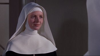 Movie still from “The Nun's Story” (1959), directed by Fred Zinnemann – A woman wearing a nun's habit and a white head covering; Close Up shot, Low angle