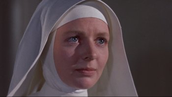 Movie still from “The Nun's Story” (1959), directed by Fred Zinnemann – A woman wearing a nun's habit and a white head covering; Close Up shot, Low angle