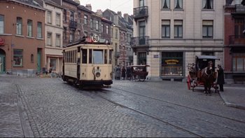 Movie still from “The Nun's Story” (1959), directed by Fred Zinnemann – An old fashioned trolley is driving down the street; Extreme Wide shot, High angle