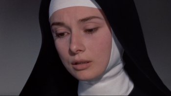 Movie still from “The Nun's Story” (1959), directed by Fred Zinnemann – A woman wearing a nun's habit and a white head scarf; Close Up shot, High angle