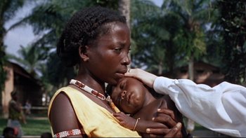 Movie still from “The Nun's Story” (1959), directed by Fred Zinnemann – A woman holding a baby in her arms; Close Up shot, High angle