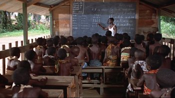 Movie still from “The Nun's Story” (1959), directed by Fred Zinnemann – A group of children in a classroom with a teacher; Wide shot, High angle