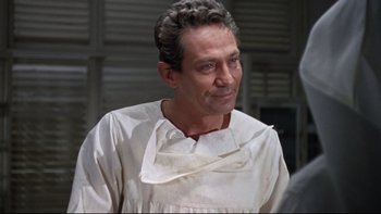 Movie still from “The Nun's Story” (1959), directed by Fred Zinnemann – A person wearing a white shirt; Close Up shot, Over the shoulder angle