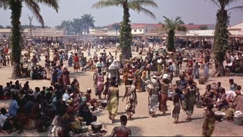 Movie still from “The Nun's Story” (1959), directed by Fred Zinnemann – A large group of people gathered on a beach; Extreme Wide shot, High angle