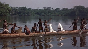 Movie still from “The Nun's Story” (1959), directed by Fred Zinnemann – A group of people in a boat on a body of water; Wide shot, High angle
