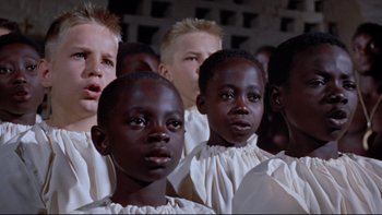 Movie still from “The Nun's Story” (1959), directed by Fred Zinnemann – A group of young boys in white shirts and white shirts; Close Up shot, High angle