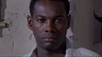 Movie still from “The Nun's Story” (1959), directed by Fred Zinnemann – A person wearing a white shirt; Close Up shot, Low angle