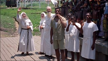 Movie still from “The Nun's Story” (1959), directed by Fred Zinnemann – A group of people standing next to each other on a dock; Wide shot, High angle