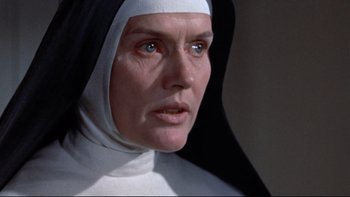Movie still from “The Nun's Story” (1959), directed by Fred Zinnemann – A woman in a nun's outfit looking at the camera; Close Up shot, Low angle