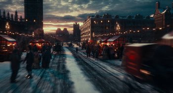 Movie still from “The Nutcracker and the Four Realms” (2018), directed by Joe Johnston – A street scene with people walking on the sidewalk; Extreme Wide shot, High angle