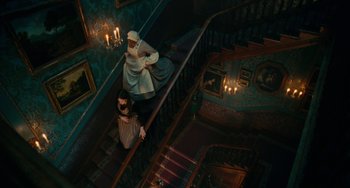 Movie still from “The Nutcracker and the Four Realms” (2018), directed by Joe Johnston – A woman and a man climbing up the stairs; Extreme Wide shot, Overhead angle