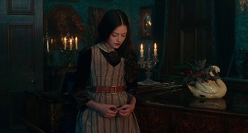 Movie still from “The Nutcracker and the Four Realms” (2018), directed by Joe Johnston – A young girl standing in front of a fireplace; Medium shot, Over the shoulder angle